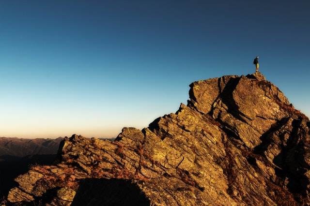 man climbing mountain