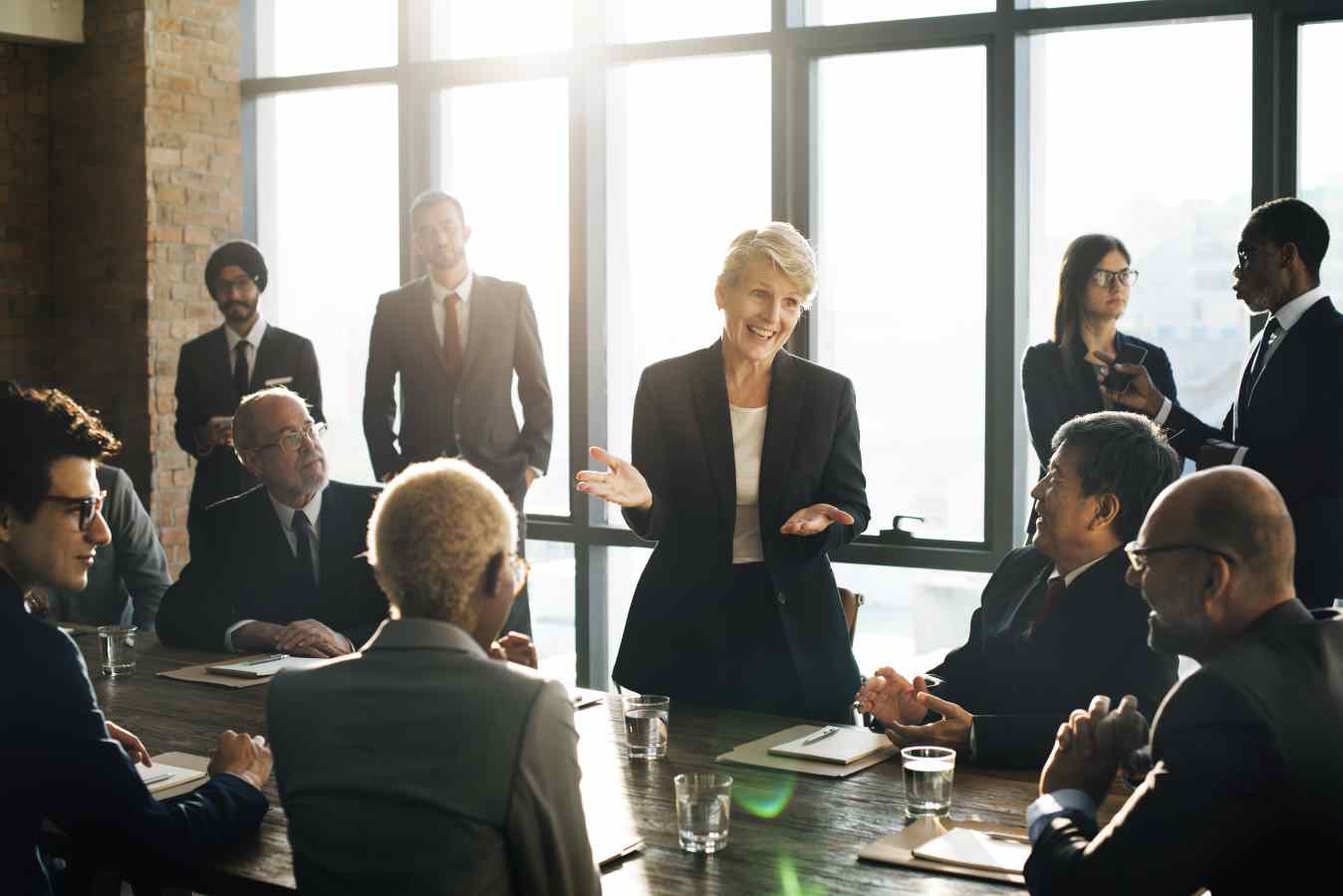 woman presenting to room of other business people